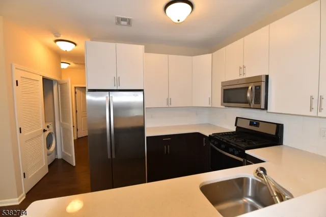 a kitchen with a refrigerator sink and microwave