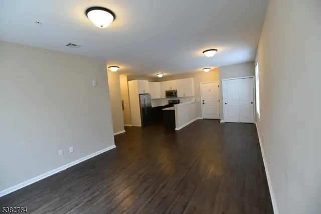 a view of a kitchen with a sink and a refrigerator