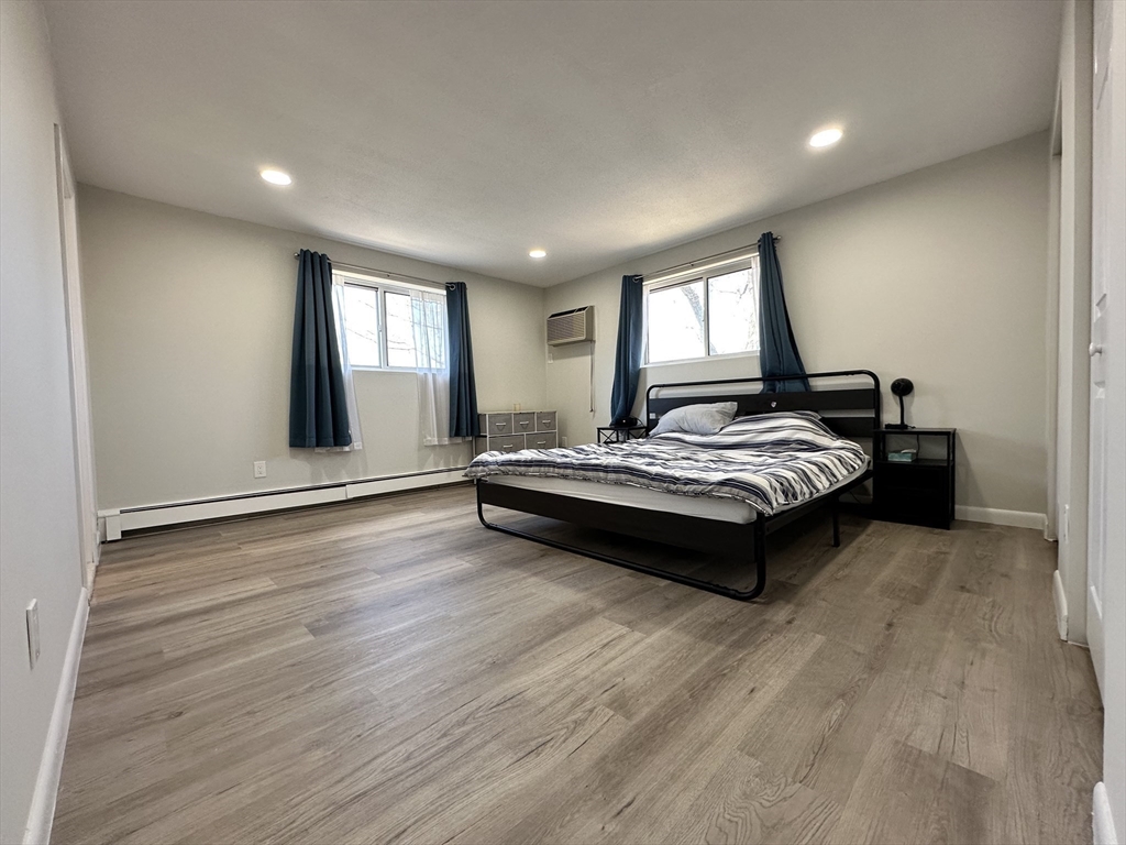 73 Charlesbank Road, Unit 306 Newton, MA 02458 - Photo 4 of 11 a spacious bedroom with a bed and window