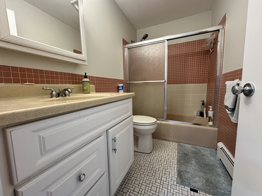 73 Charlesbank Road, Unit 306 Newton, MA 02458 - Photo 8 of 11 a bathroom with a sink toilet and shower