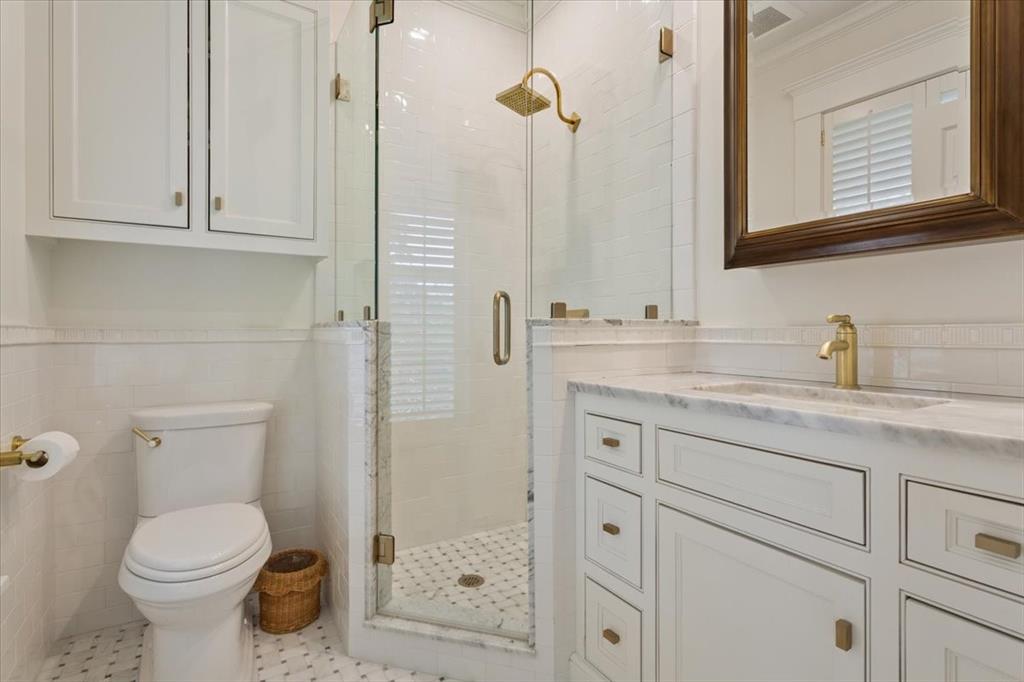 410 Rice Avenue Waco, TX 76708 - Photo 23 of 40 a bathroom with a granite countertop toilet sink and mirror
