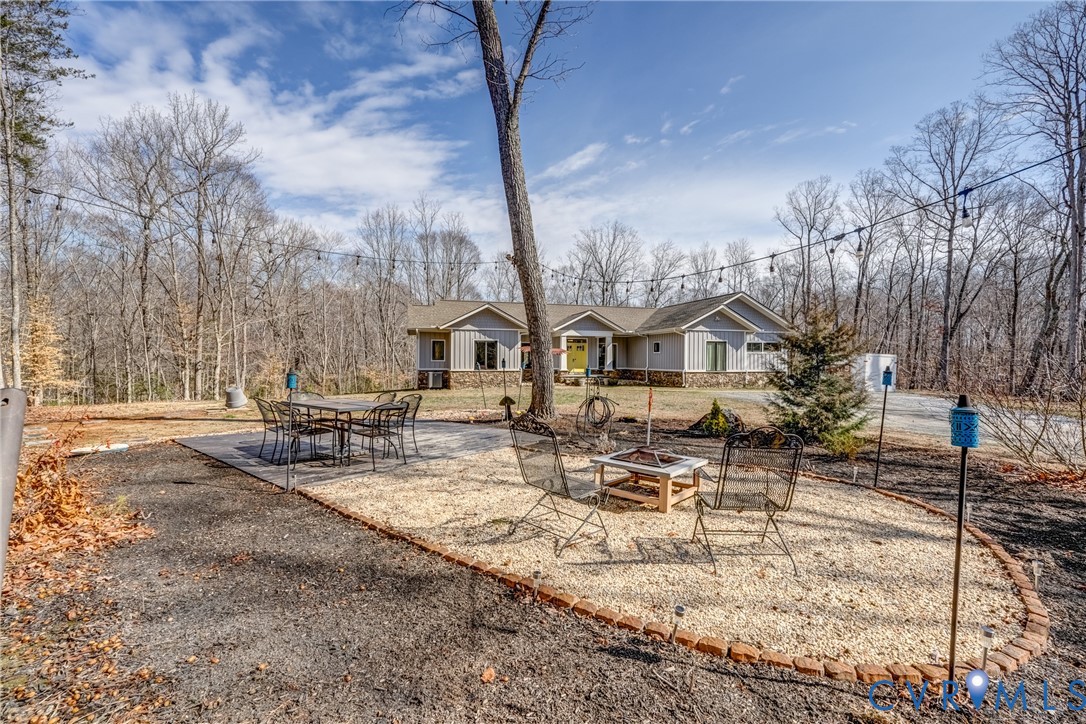 33051 Walnut Grove Farm Lane Hanover, VA 23069 - Photo 14 of 76 a view of a patio with table and chairs with wooden fence