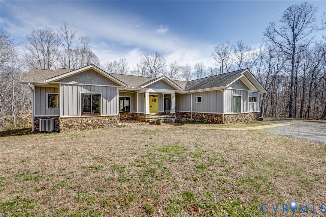 33051 Walnut Grove Farm Lane Hanover, VA 23069 - Photo 3 of 76 a front view of a house with a garden and trees