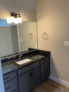 a bedroom with a bed and a painting on the wall