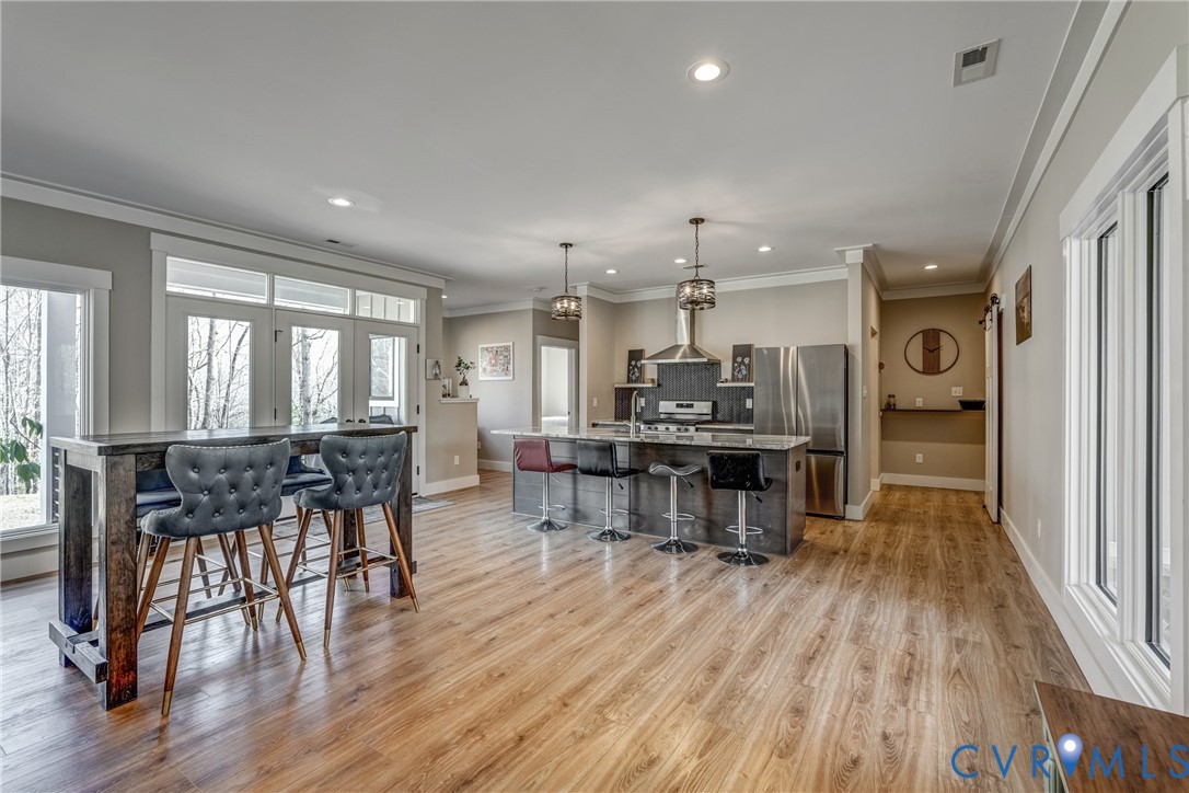 33051 Walnut Grove Farm Lane Hanover, VA 23069 - Photo 44 of 76 an open kitchen with a table and chairs in it