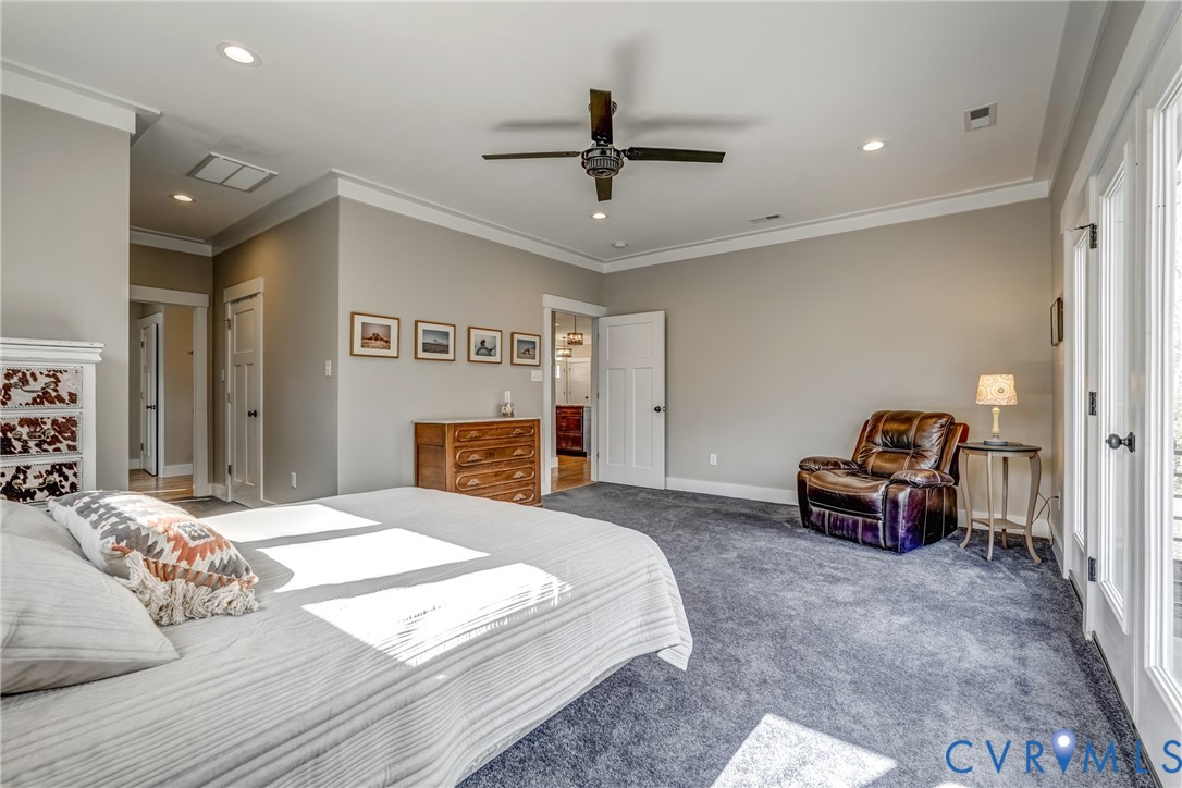 33051 Walnut Grove Farm Lane Hanover, VA 23069 - Photo 60 of 76 a spacious bedroom with a bed and a chandelier