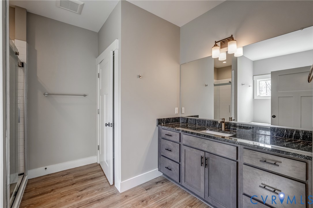 33051 Walnut Grove Farm Lane Hanover, VA 23069 - Photo 62 of 76 a bathroom with a double vanity sink and a mirror