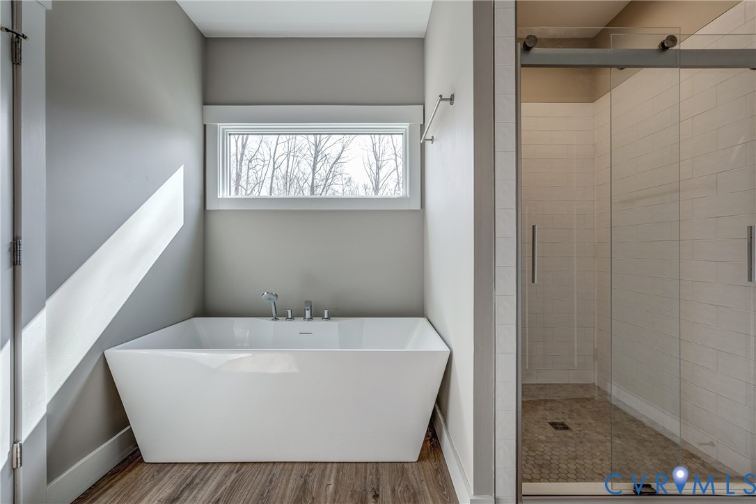 33051 Walnut Grove Farm Lane Hanover, VA 23069 - Photo 63 of 76 a white bath tub sitting under a bathroom
