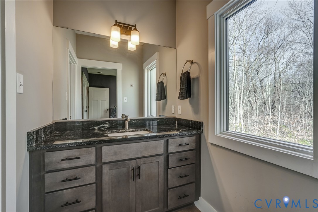 33051 Walnut Grove Farm Lane Hanover, VA 23069 - Photo 69 of 76 a bathroom with a granite countertop sink vanity mirror next to a window
