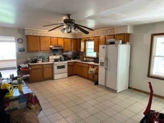 12257 Waterman Road Waterman, IL 60556 - Photo 19 of 22 a kitchen with refrigerator and window