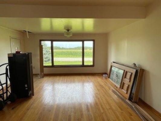 12257 Waterman Road Waterman, IL 60556 - Photo 20 of 22 a view of an empty room with wooden floor and a window