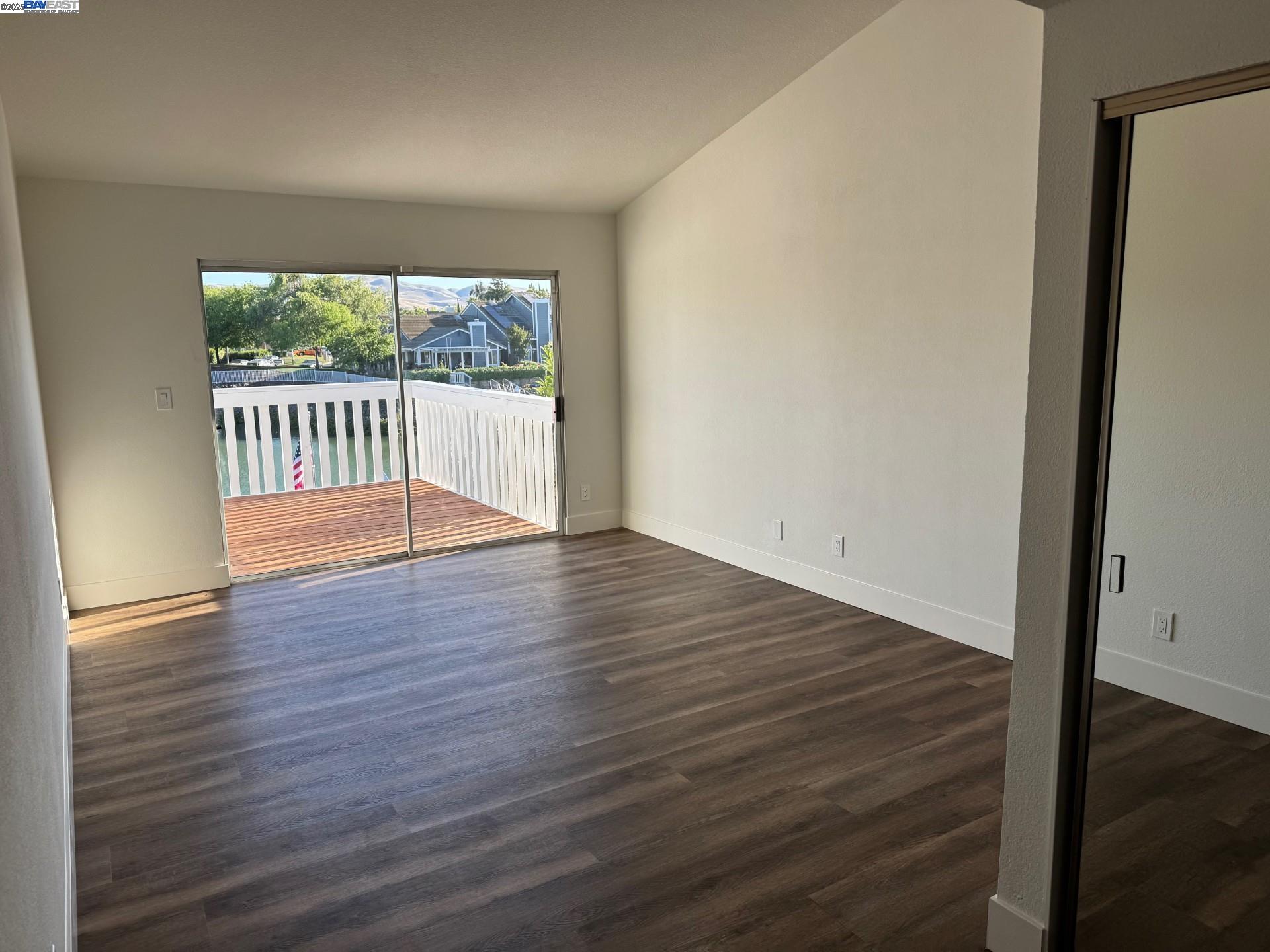 118 Pelican Loop Pittsburg, CA 94565 - Photo 14 of 21 a view of an empty room with wooden floor and a window