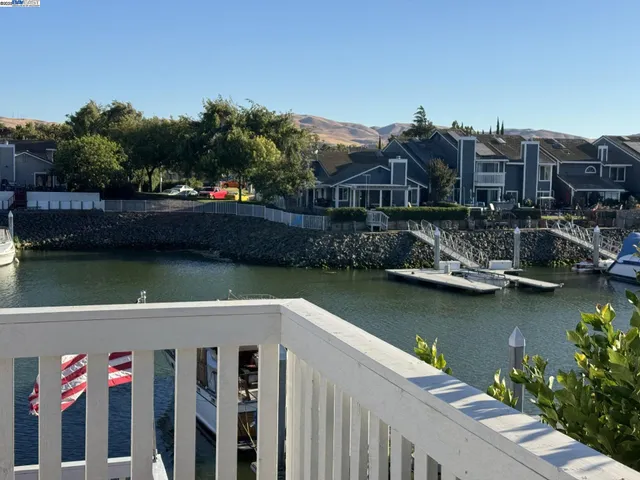 a view of balcony with wooden floor and lake view
