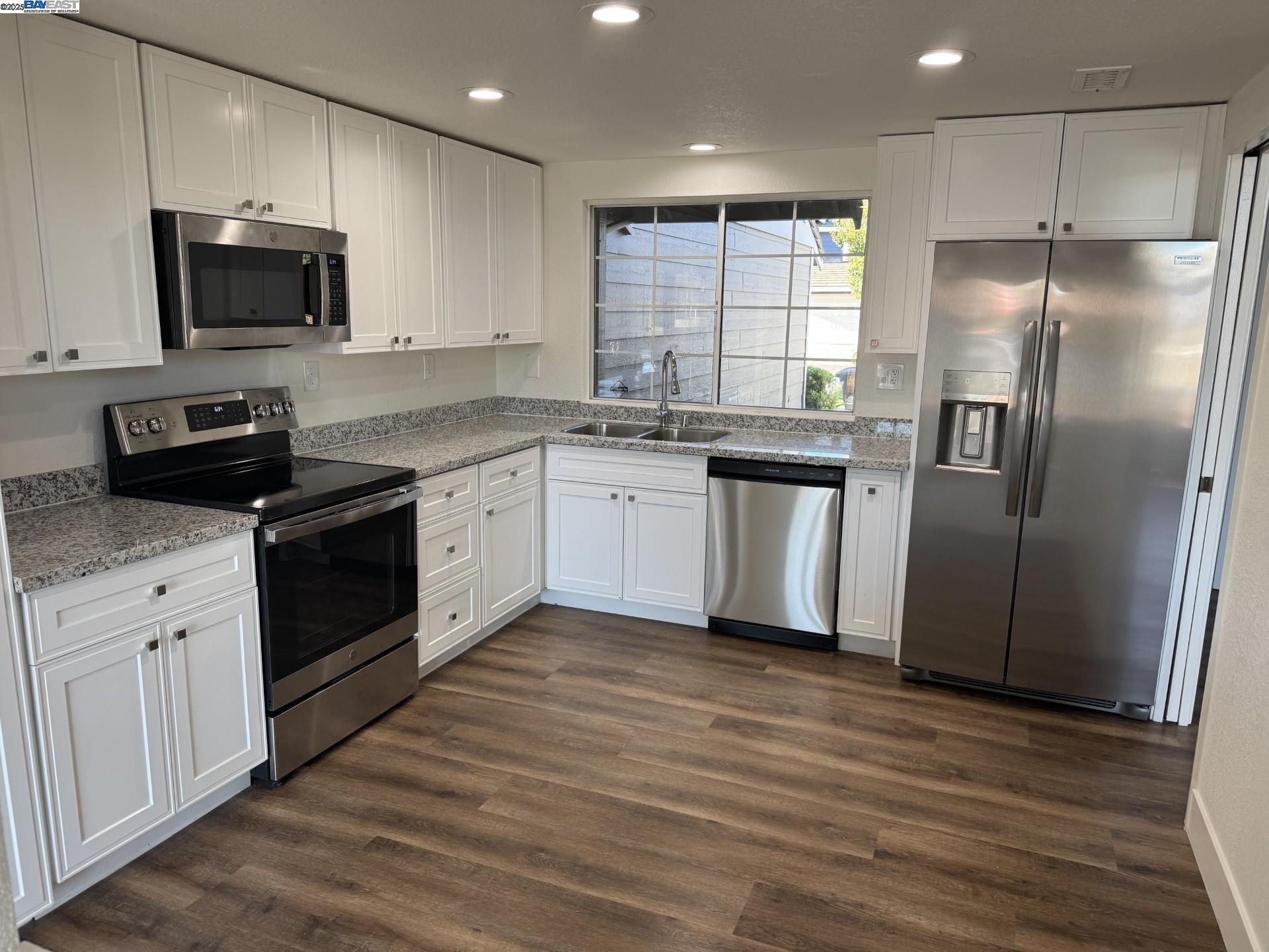 118 Pelican Loop Pittsburg, CA 94565 - Photo 4 of 21 a kitchen with stainless steel appliances granite countertop a refrigerator a sink dishwasher a stove and a microwave oven on granite countertops
