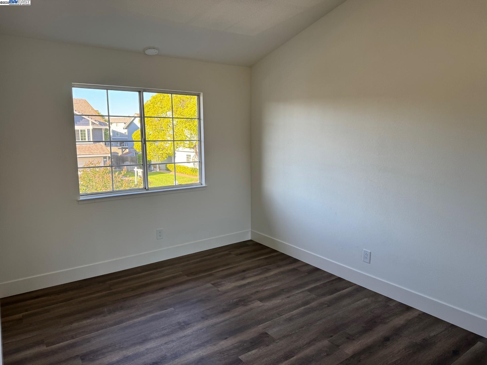 118 Pelican Loop Pittsburg, CA 94565 - Photo 9 of 21 a view of an empty room with wooden floor and a window