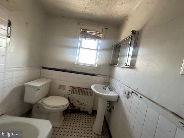 554 Wiltshire Road Upper Darby, PA 19082 - Photo 14 of 18 a white toilet sitting next to a bathroom sink