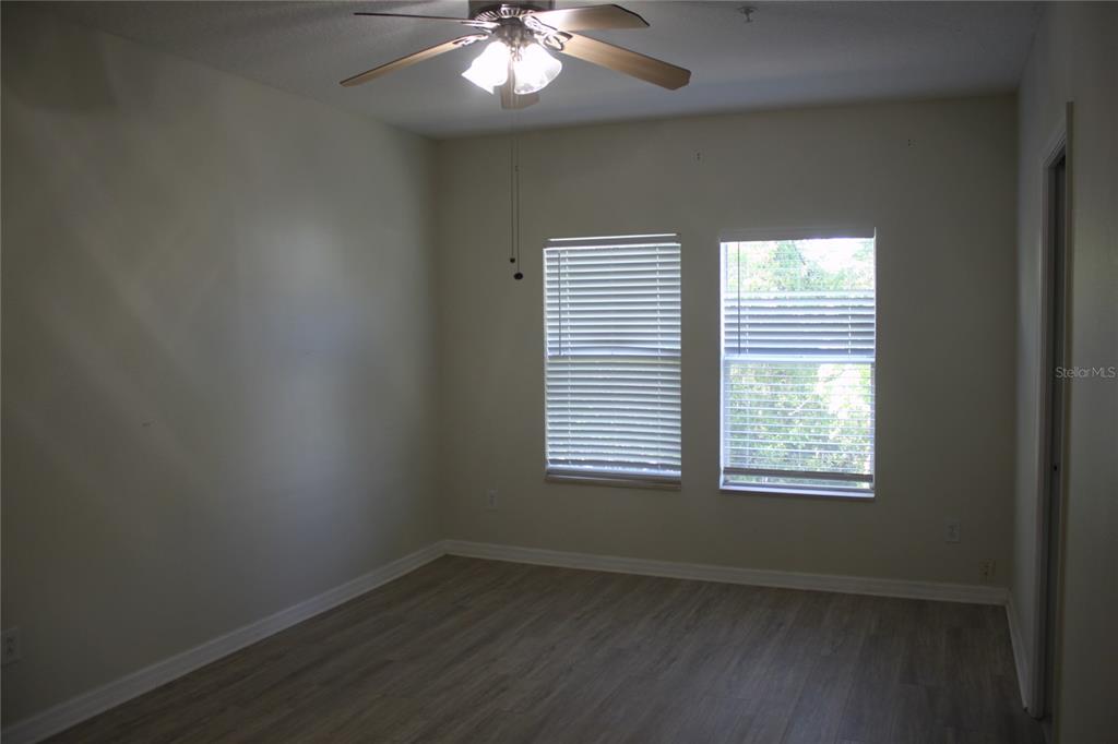 3222 Villa Strada Way Orlando, FL 32835 - Photo 14 of 26 a view of an empty room with wooden floor and a window