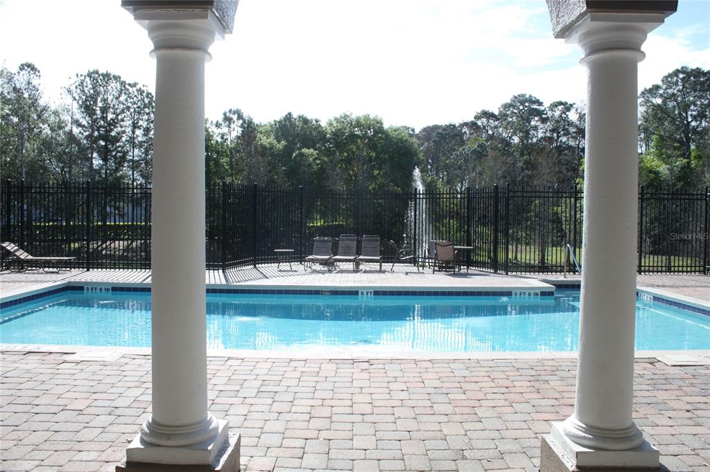 3222 Villa Strada Way Orlando, FL 32835 - Photo 25 of 26 a view of swimming pool with a table and chairs