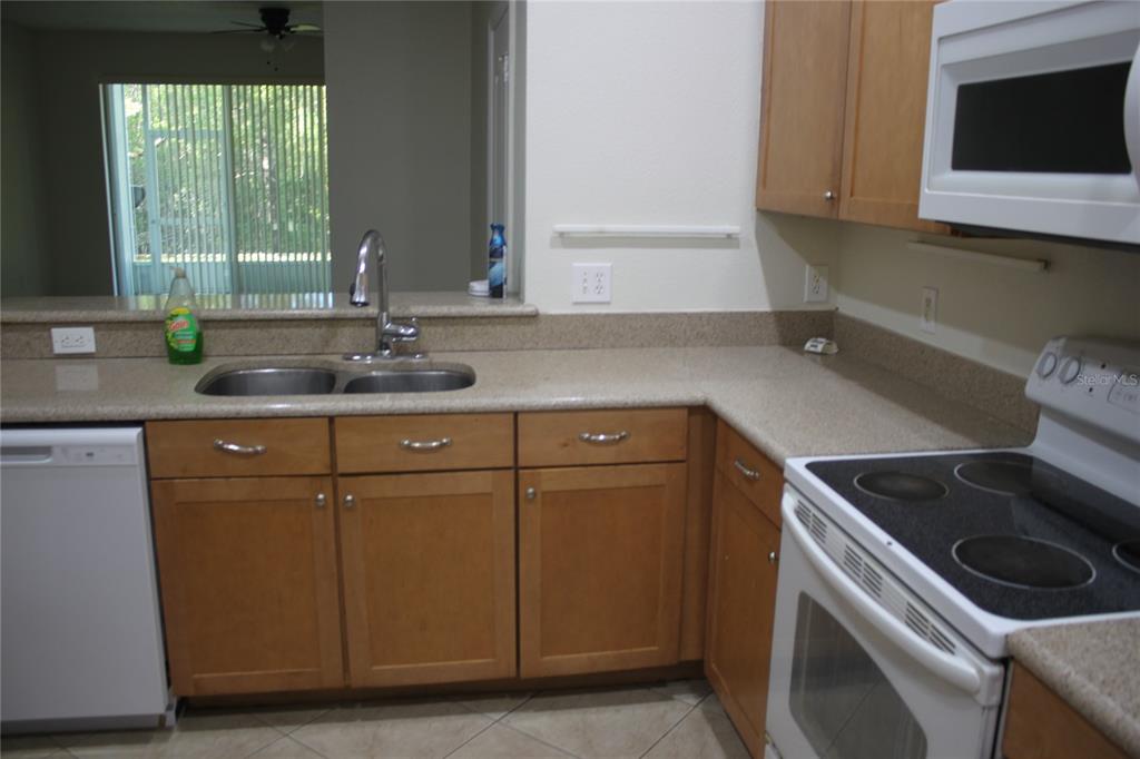 3222 Villa Strada Way Orlando, FL 32835 - Photo 5 of 26 a kitchen with a sink and a stove top oven