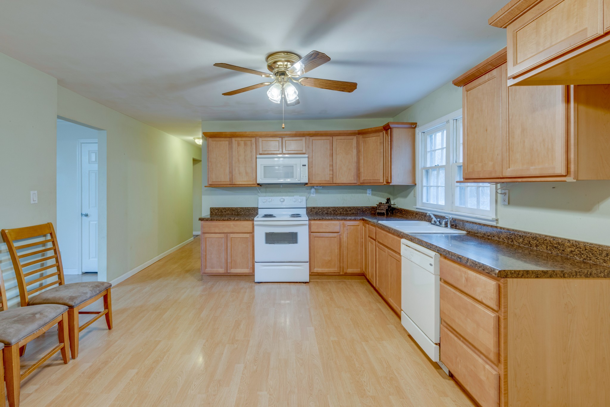 240 East Piney Road Dickson, TN 37055 - Photo 8 of 24 a kitchen with stainless steel appliances granite countertop a sink cabinets and wooden floor