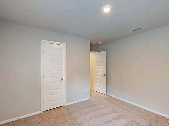 an empty room with closet area