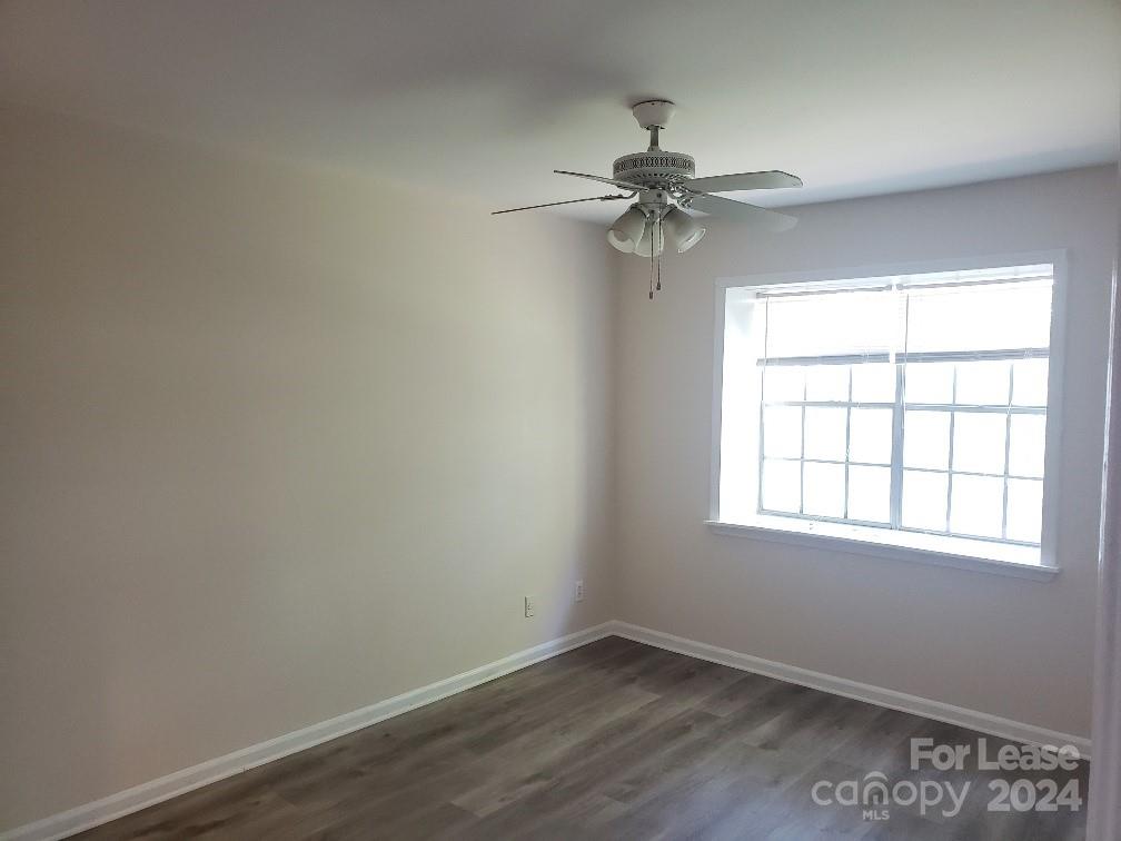 5808 Hunting Ridge Lane Charlotte, NC 28212 - Photo 5 of 6 an empty room with a window and a fan