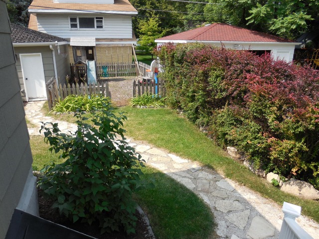 250 Lawton Road Riverside, IL 60546 - Photo 22 of 25 a house view with a garden space