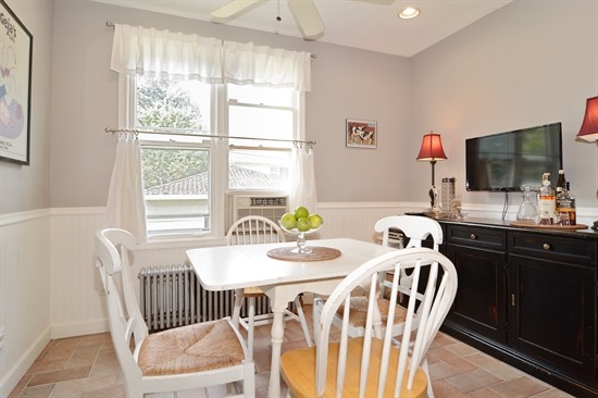 250 Lawton Road Riverside, IL 60546 - Photo 8 of 25 a dining room with furniture a window and a chandelier