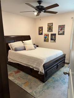 a bedroom with a bed and wall painting