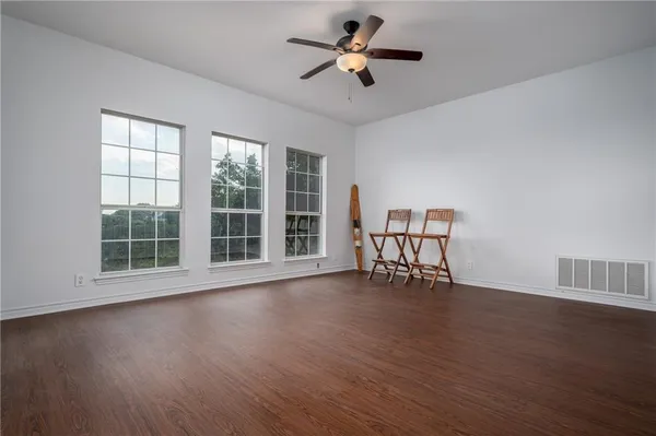 a view of workspace with wooden floor and a ceiling fan