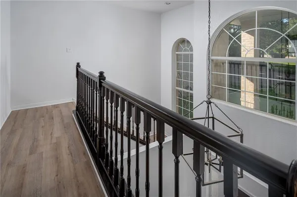 a view of staircase with wooden floor and a front door