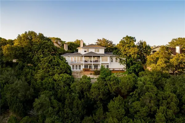 a view of a large building with a tree in front of it