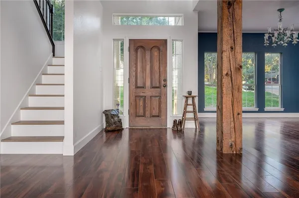 a view of an entryway with wooden floor