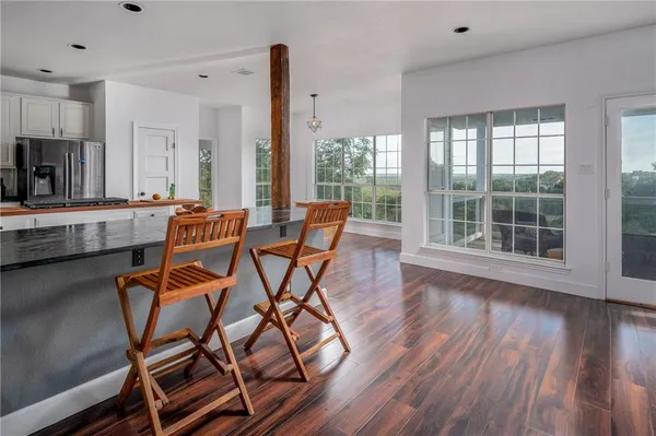 a dining room with furniture and wooden floor