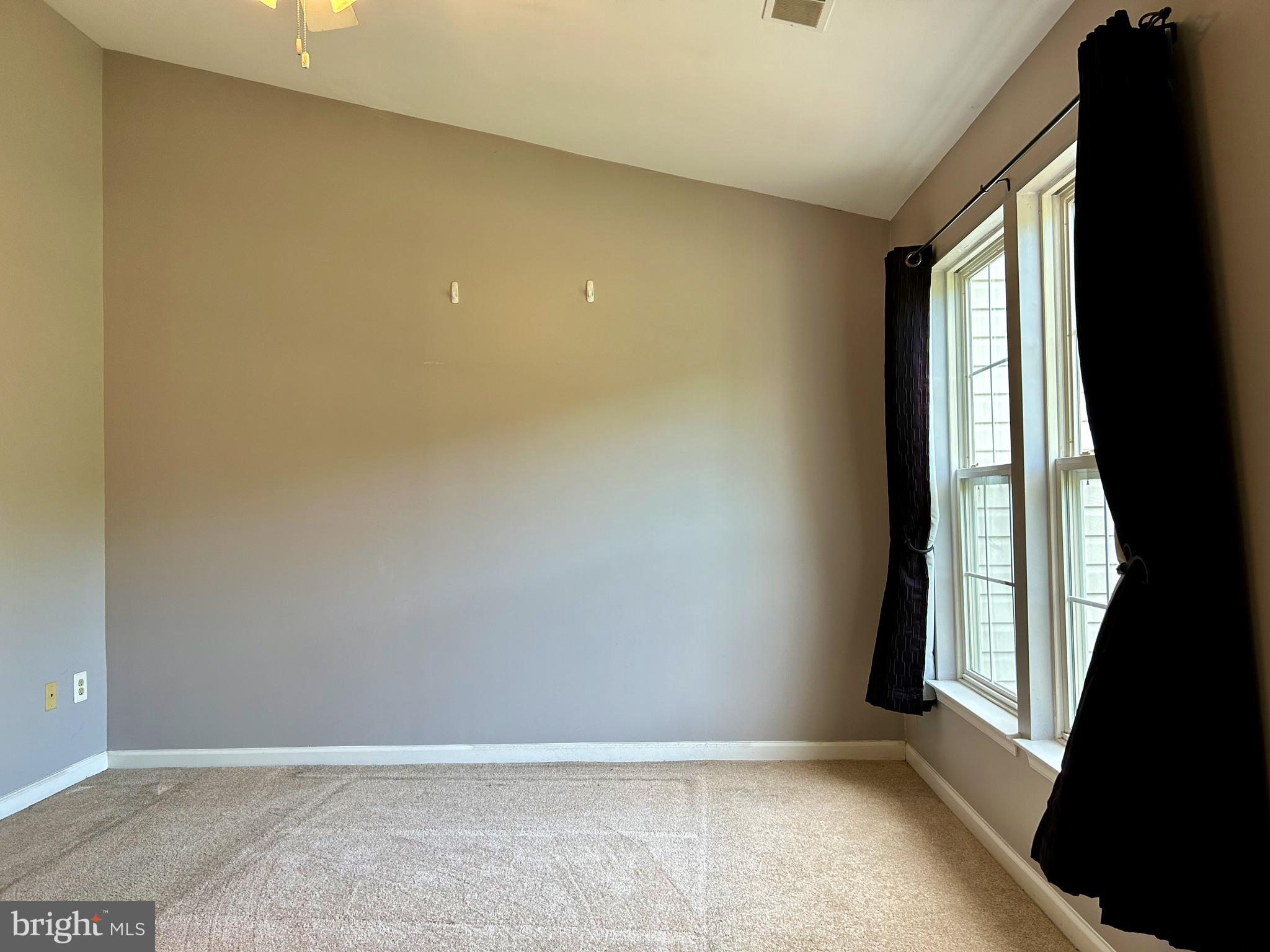 55 Alexis Drive Newark, DE 19702 - Photo 17 of 27 an empty room with large windows