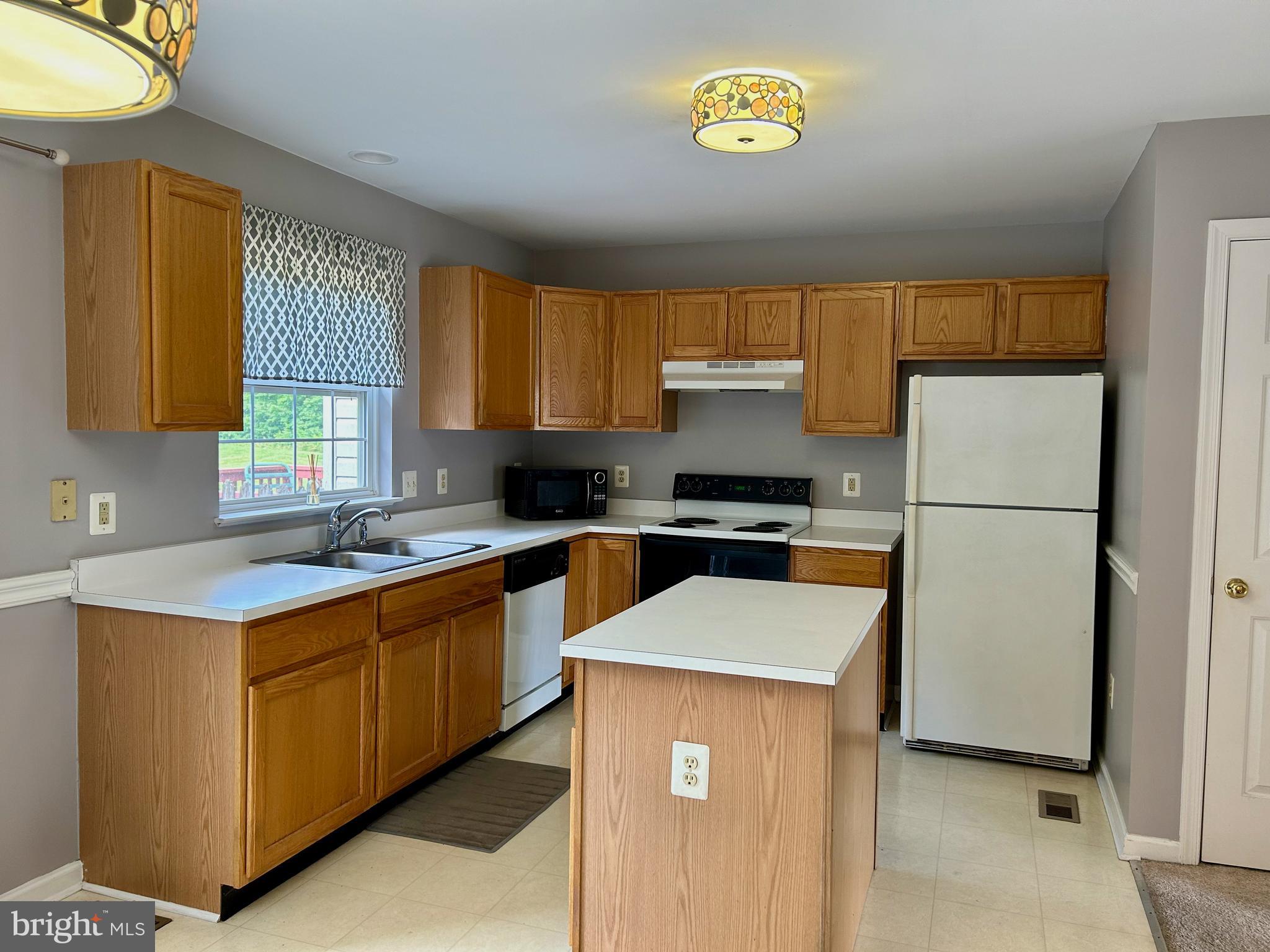 55 Alexis Drive Newark, DE 19702 - Photo 6 of 27 a kitchen with stainless steel appliances granite countertop a refrigerator a sink a stove a microwave a sink and a refrigerator