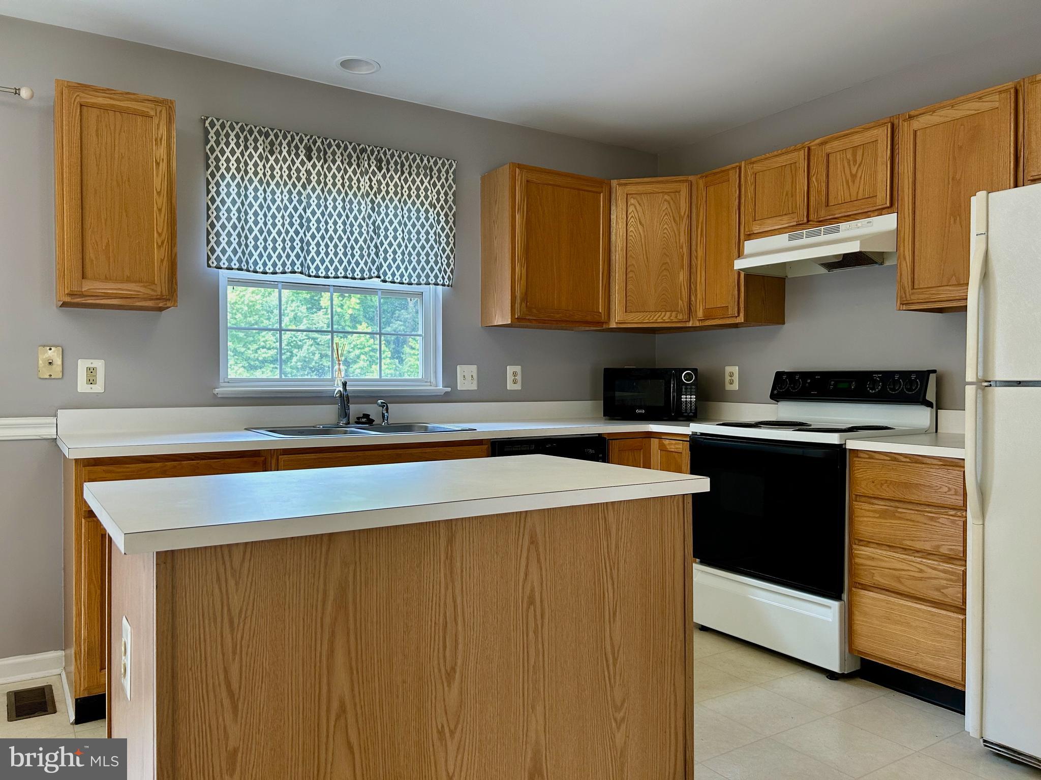 55 Alexis Drive Newark, DE 19702 - Photo 7 of 27 a kitchen with cabinets window and stainless steel appliances