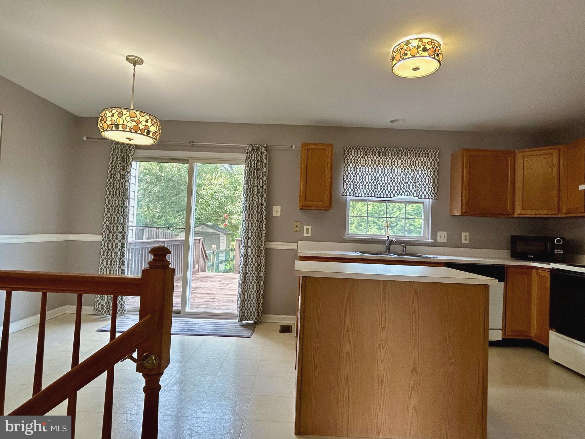 55 Alexis Drive Newark, DE 19702 - Photo 10 of 27 a kitchen with stainless steel appliances granite countertop a stove a sink dishwasher a refrigerator and a dining table with wooden floor