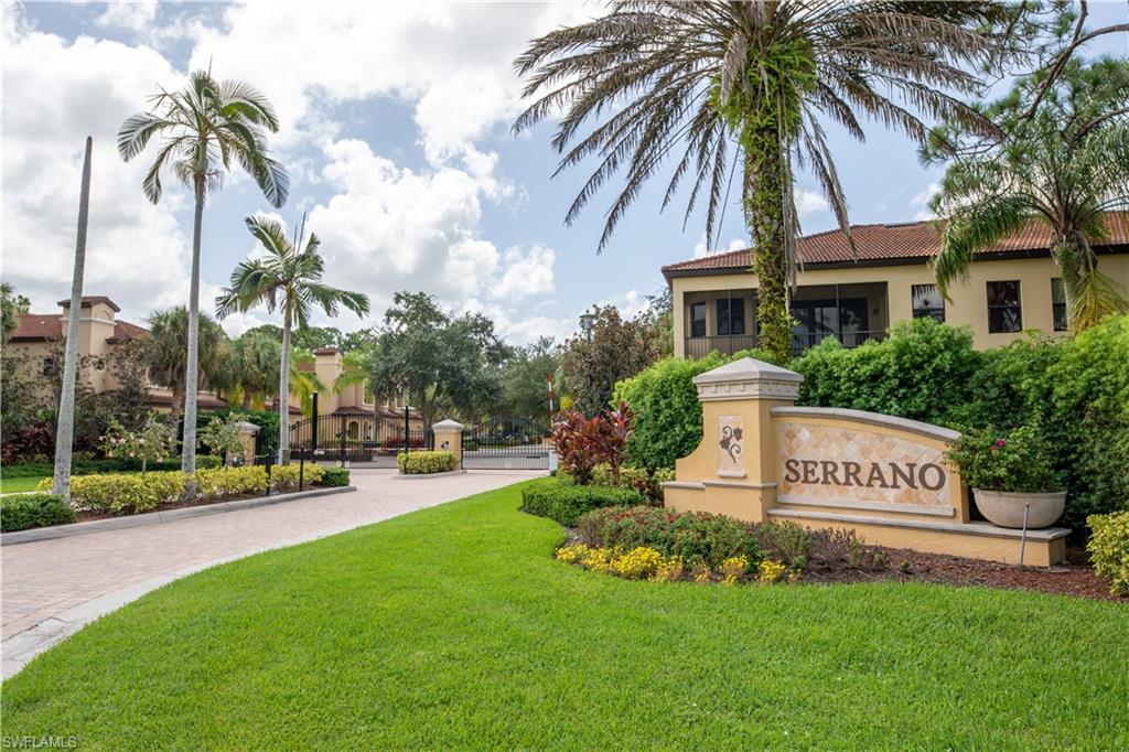 a view of a house with a yard and palm trees
