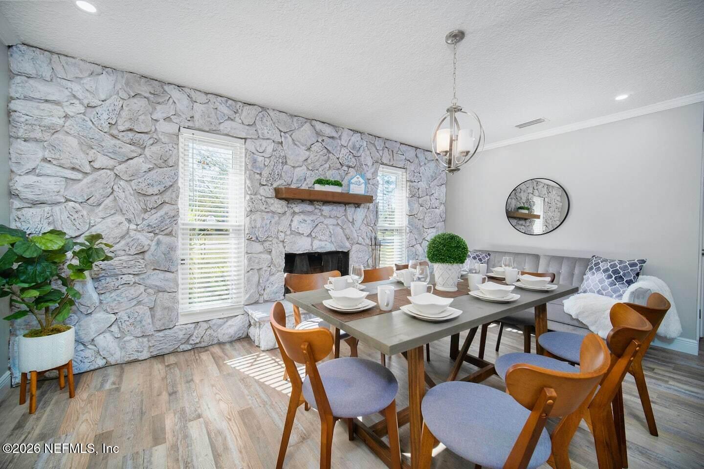 11613 Lake Ride Drive Jacksonville, FL 32223 - Photo 13 of 42 a dining room with furniture and wooden floor