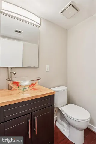 a bathroom with a toilet a sink and a mirror