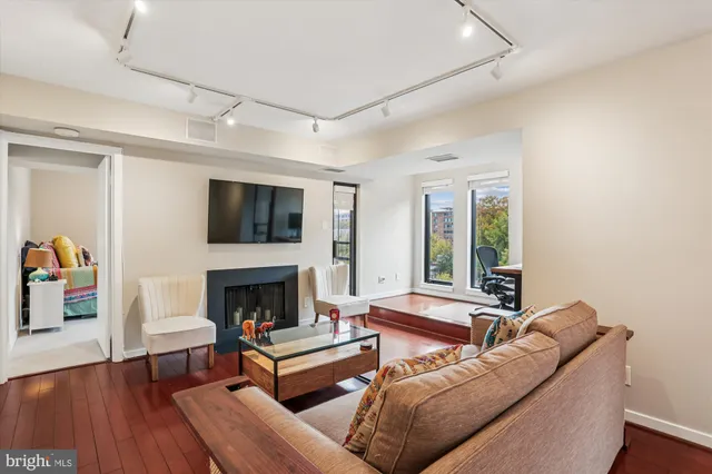 a living room with furniture fireplace and flat screen tv