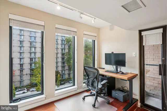 a view of a workspace with a window and chair