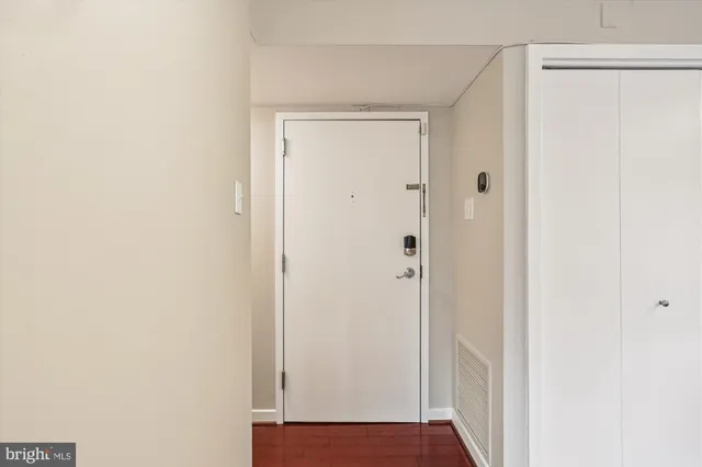 a view of a hallway with wooden floor