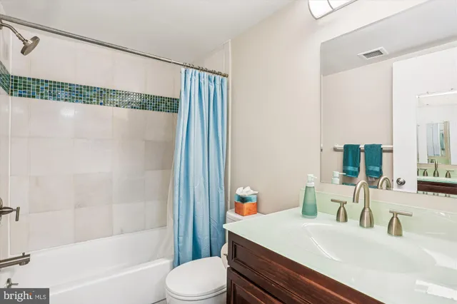 a bathroom with a sink mirror toilet and bathtub