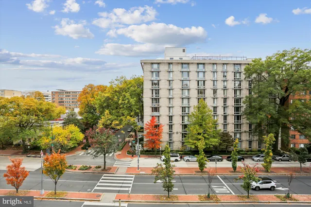 a view of cars parked on the side of a street