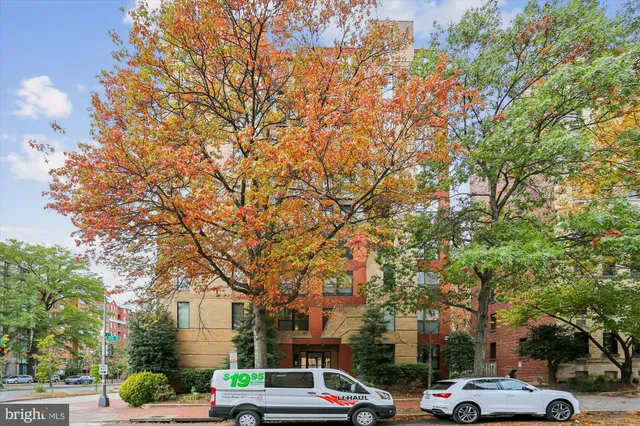 a city street lined with buildings and trees