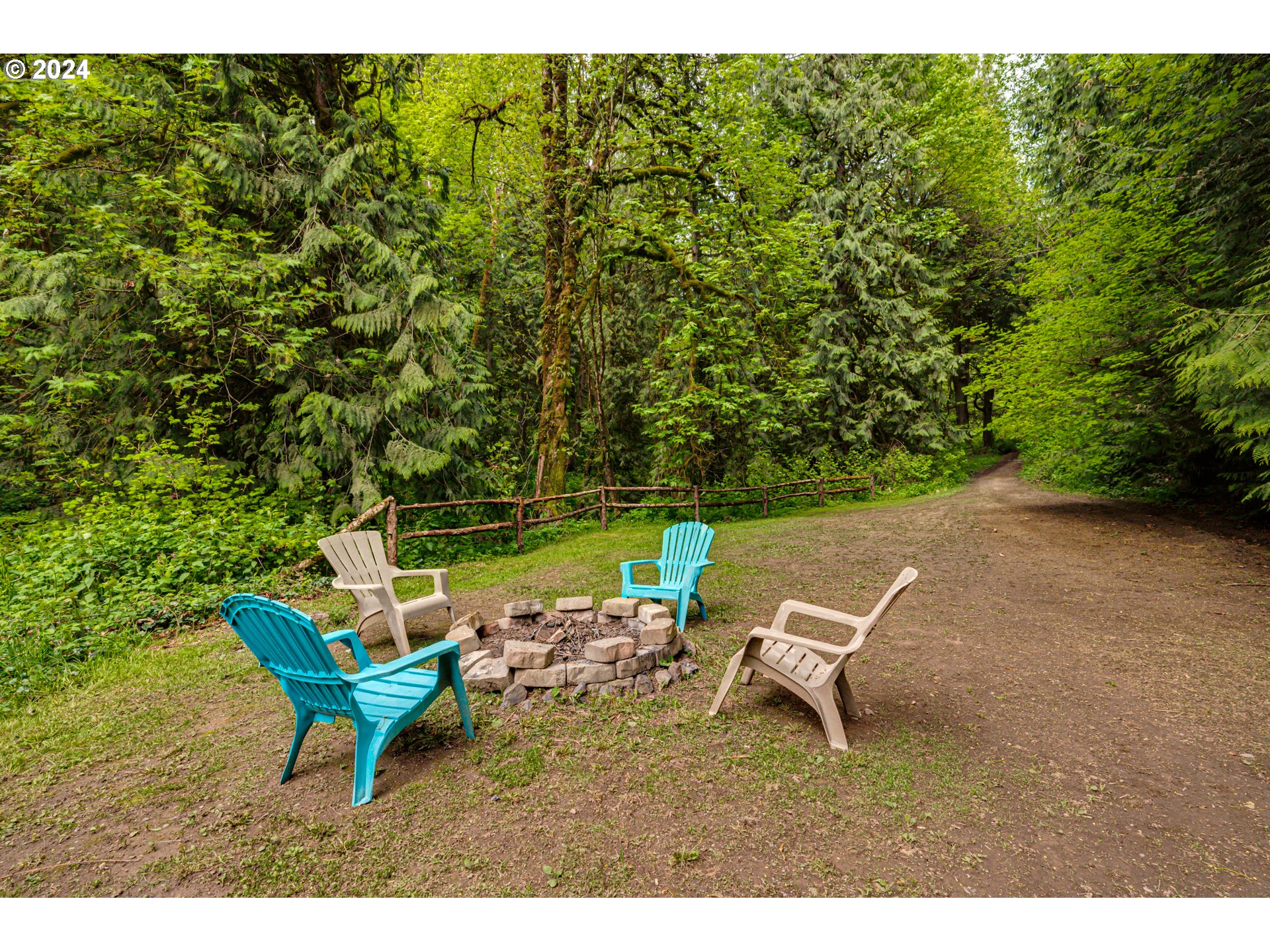 631 Clark Creek Road Longview, WA 98632 - Photo 36 of 40 a view of a lake with a table and chairs