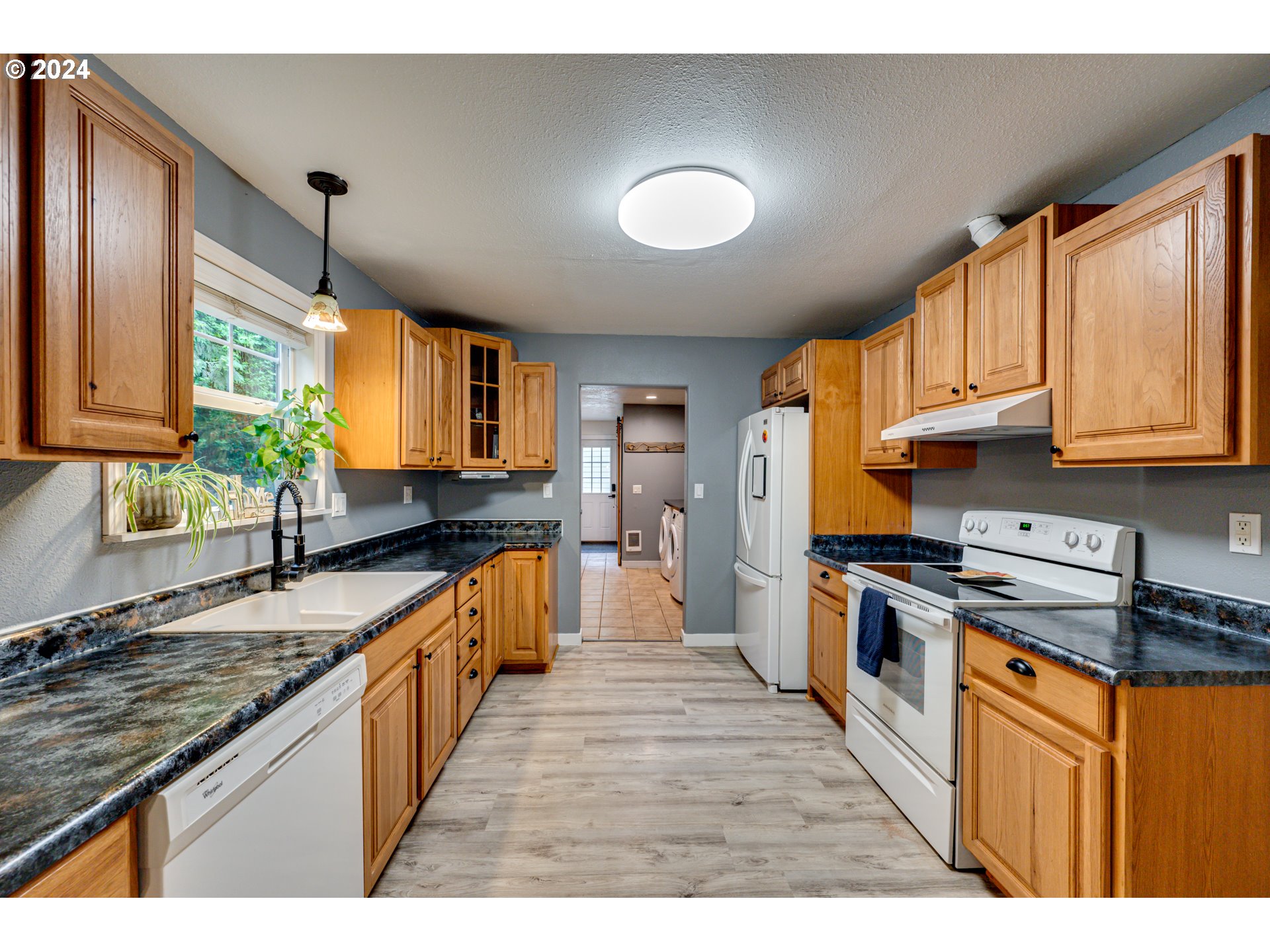 631 Clark Creek Road Longview, WA 98632 - Photo 9 of 40 a large kitchen with stainless steel appliances granite countertop a stove a sink dishwasher and a refrigerator