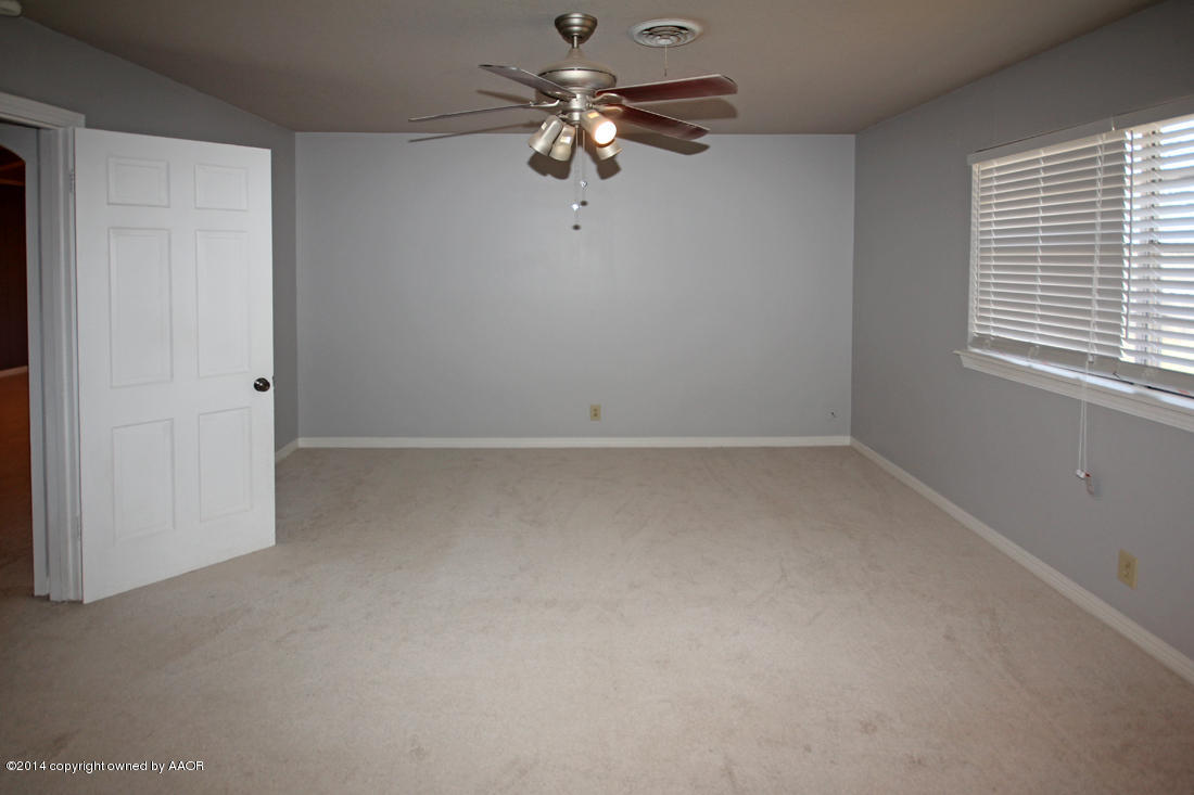 7203 Elmhurst Road Amarillo, TX 79106 - Photo 14 of 30 wooden floor in an empty room with a window